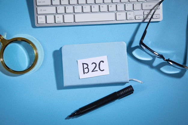 B2C on paper with a computer keyboard marker and other objects