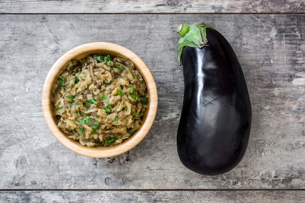 Baba ganoush in bowl on wooden table