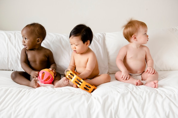 Babies playing on the bed