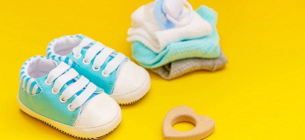 Baby accessories for newborns on a colored surface