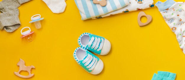 Baby accessories for newborns on a colored surface