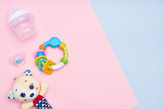 Baby accessories on pink and blue background. Flat lay . Top view Copy space.