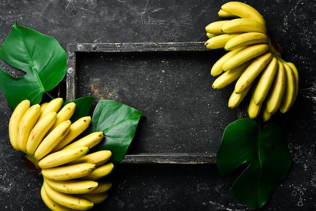 Baby banana Set of bananas in a wooden box Top view Free copy space