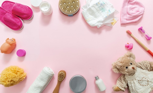 Photo baby bathing accesories on pink background top view