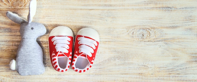 Baby booties and accessories on a light background