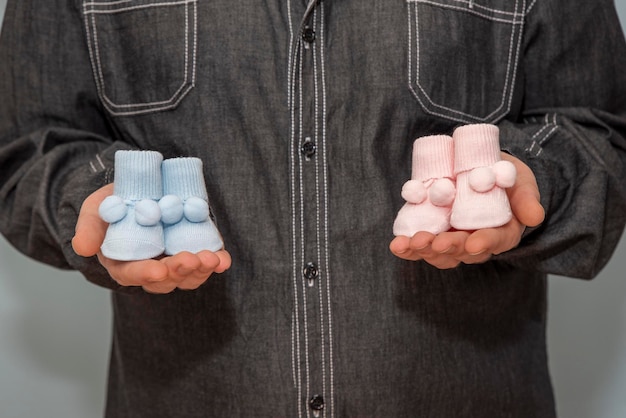 Baby booties in father's hand