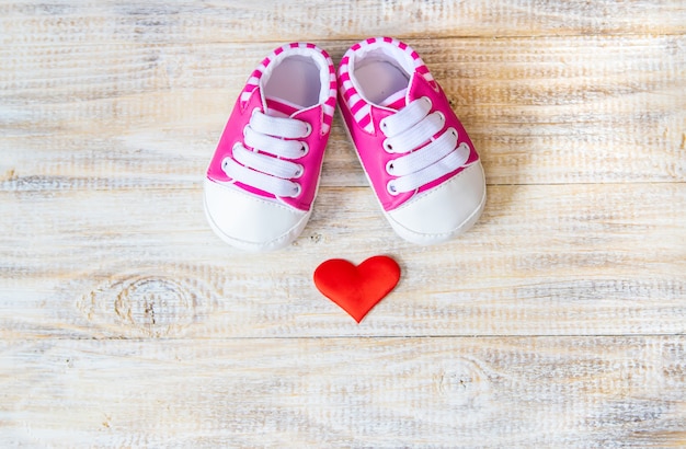 Baby booties and heart on a light. 