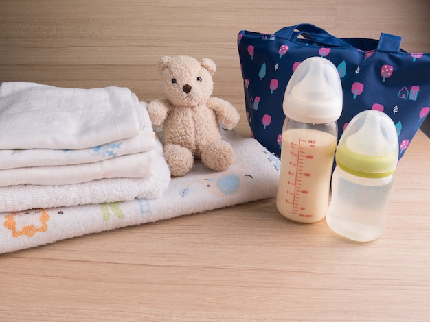 Baby bottle with milk and a measuring scale