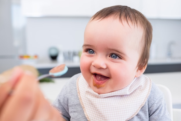 Baby boy being fed by mother