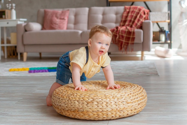 Baby boy crawls on the floor at home