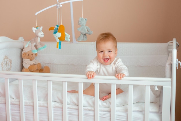 Baby boy in the crib in the children's bedroom