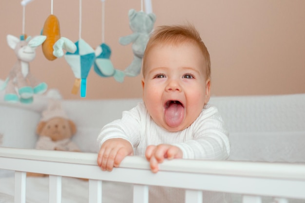 Baby boy in the crib in the children's bedroom