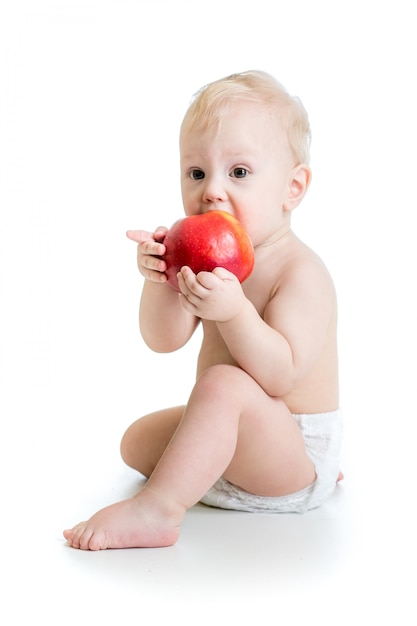 Photo baby boy eating apple, isolated on white