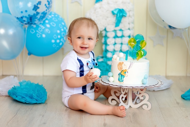 Baby boy eating his birthday cake hands