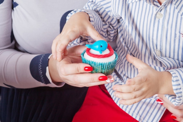 男の子と彼の母親が誕生日ケーキを保持