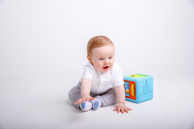 baby boy is sitting on a white background isolated