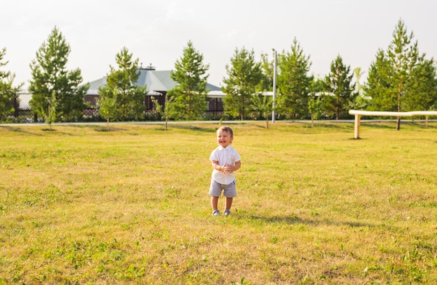 Photo baby boy laughs on a sunny day