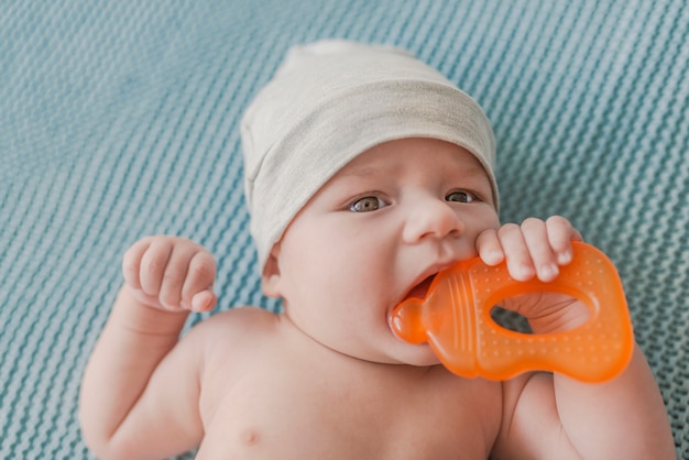 Baby boy playing with teether