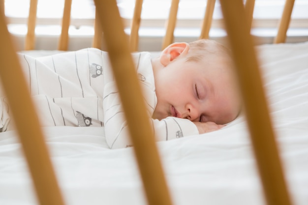 Baby boy sleeping on a cradle