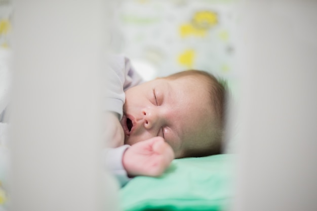 Baby boy sleeping in crib 