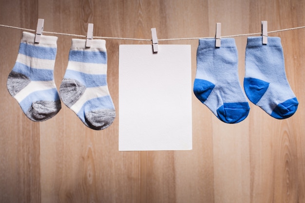 baby boy socks attached to the rope and blank card for greetings
