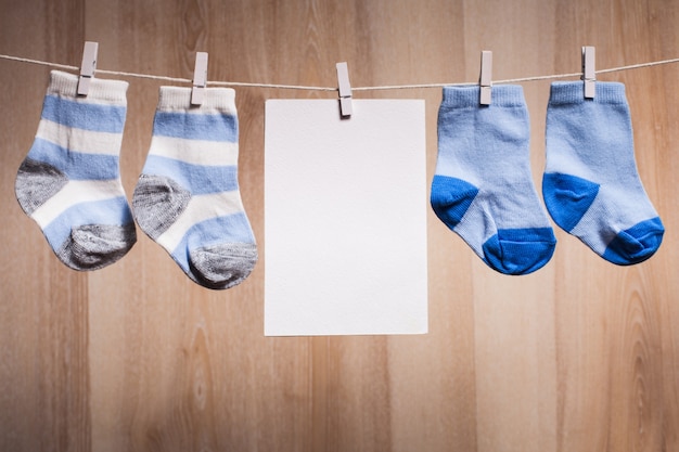 Baby boy socks attached to the rope and blank card for greetings