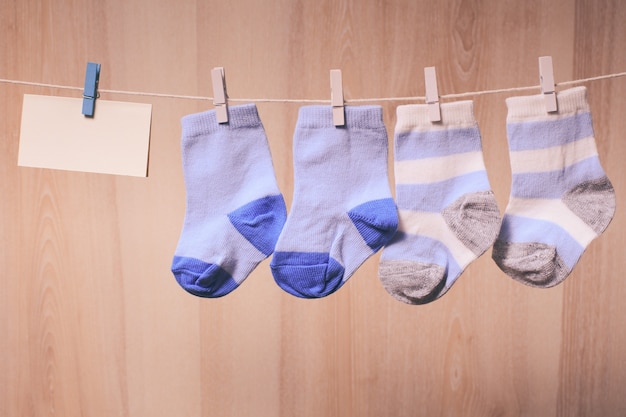 Photo baby boy socks attached to the rope and blank card for greetings