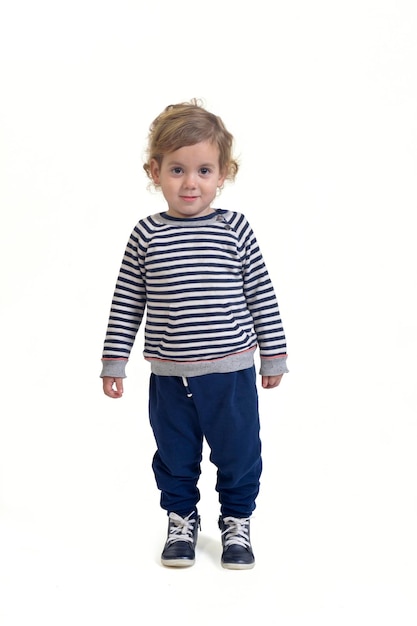 Baby boy standing and looking at camera on white background