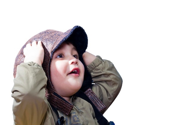 A baby boy surprised and fascinated wearing old pilot's uniform