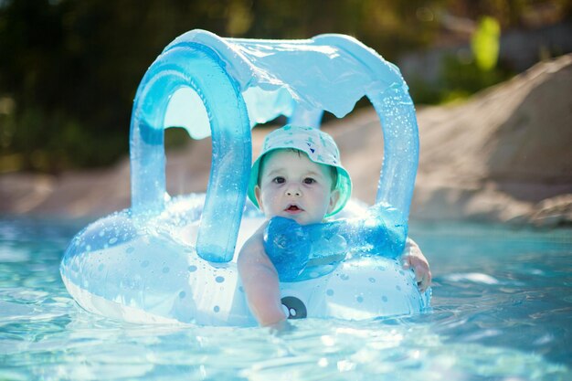 Baby boy in swimming circle bath