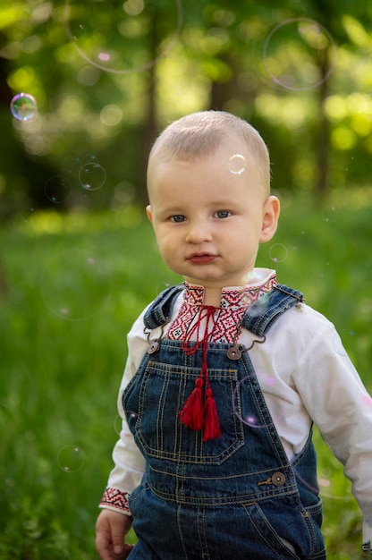 Baby boy in Ukrainian vyshyvanka in the park