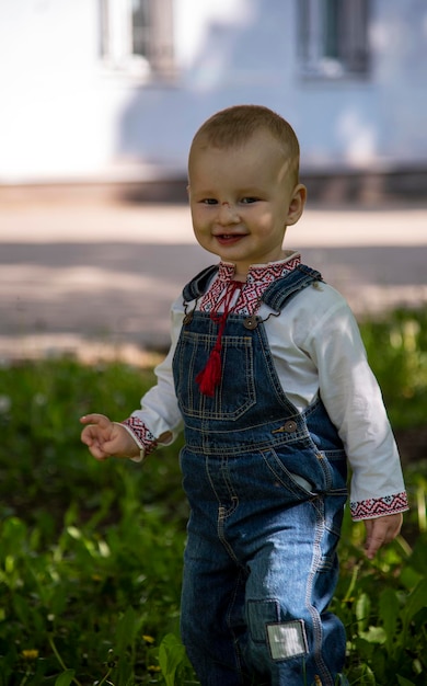 Baby boy in Ukrainian vyshyvanka in the park