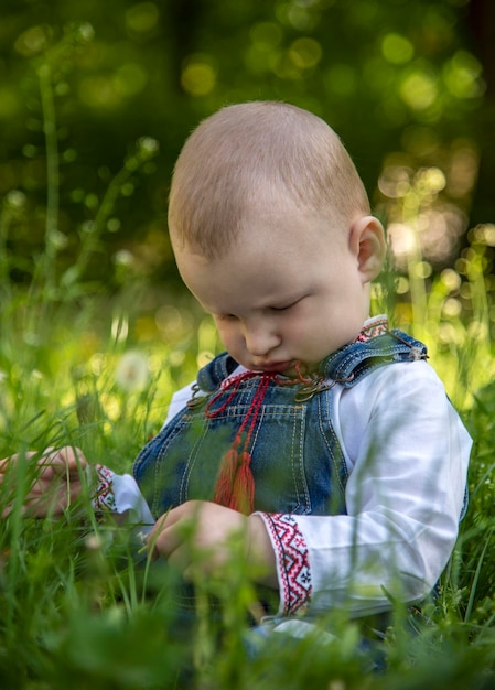 Baby boy in Ukrainian vyshyvanka in the park