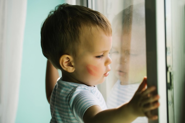 Baby boy on window sill