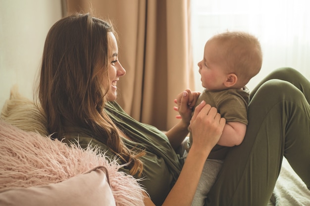 Baby boy with mother on the bed