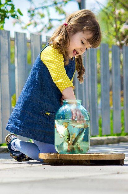 baby catches fish in a can