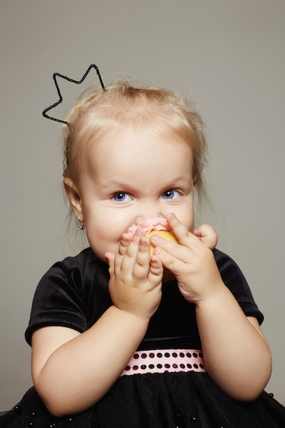 Baby child is enjoying a cake