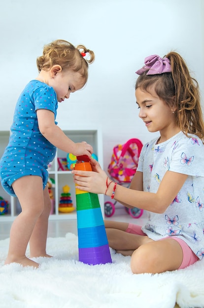 A baby child plays with toys in the playroom Selective focus