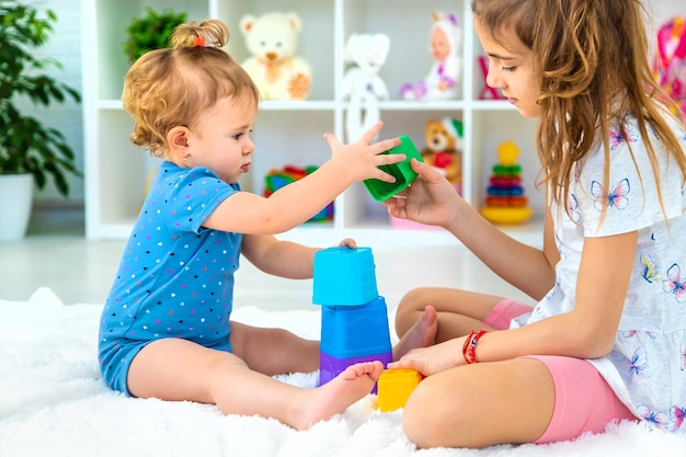 A baby child plays with toys in the playroom Selective focus