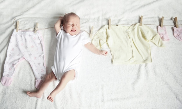 Baby clothes on the clothespin and the newborn