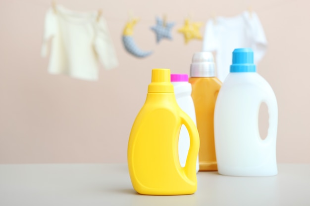 Baby clothes and detergents on the table baby clothes care concept