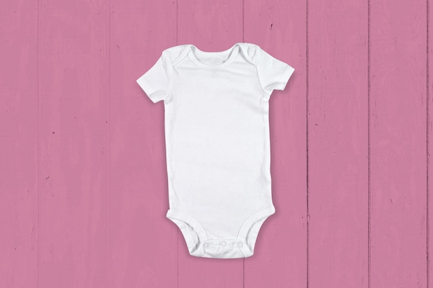 Photo baby clothes mockup on light pink wood background