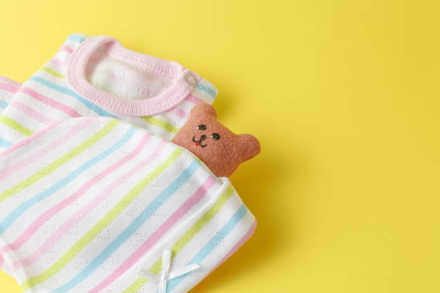 Baby clothing on a yellow surface