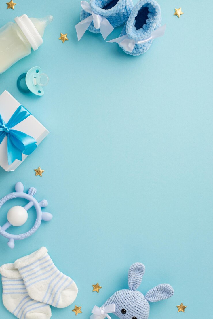 Photo baby concept top view vertical photo of giftbox shoes socks pacifier teether milk bottle knitted bunny rattle toy and gold stars on isolated pastel blue background with copyspace