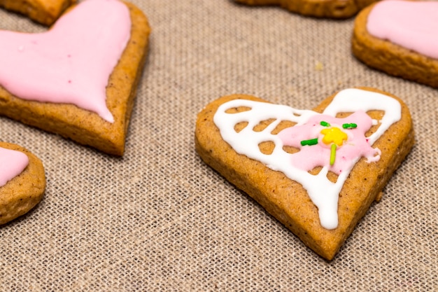 Photo baby cookie on burlap in a heart shape.