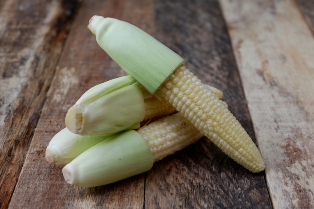 Baby corn on a wooden background