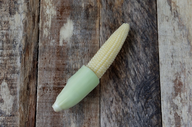 Baby corn on a wooden background