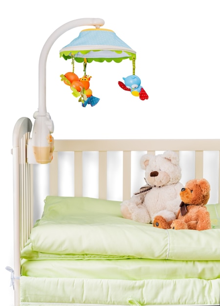 Baby cot with toys on  background