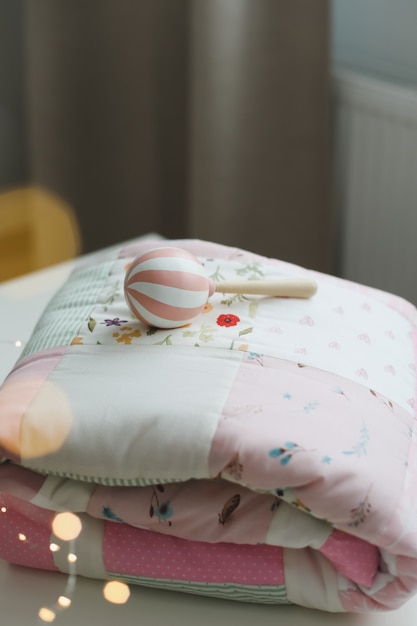 baby crib with pink patchwork blanket and textile for children nursery