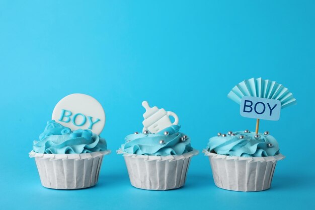 Baby Cupcakes with Toppers on Light Blue Background